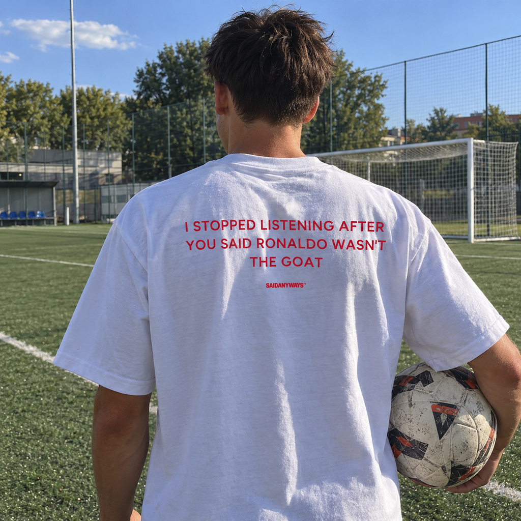 I Stopped Listening After You Said Ronaldo Wasn't The GOAT white tee, worn on a football pitch