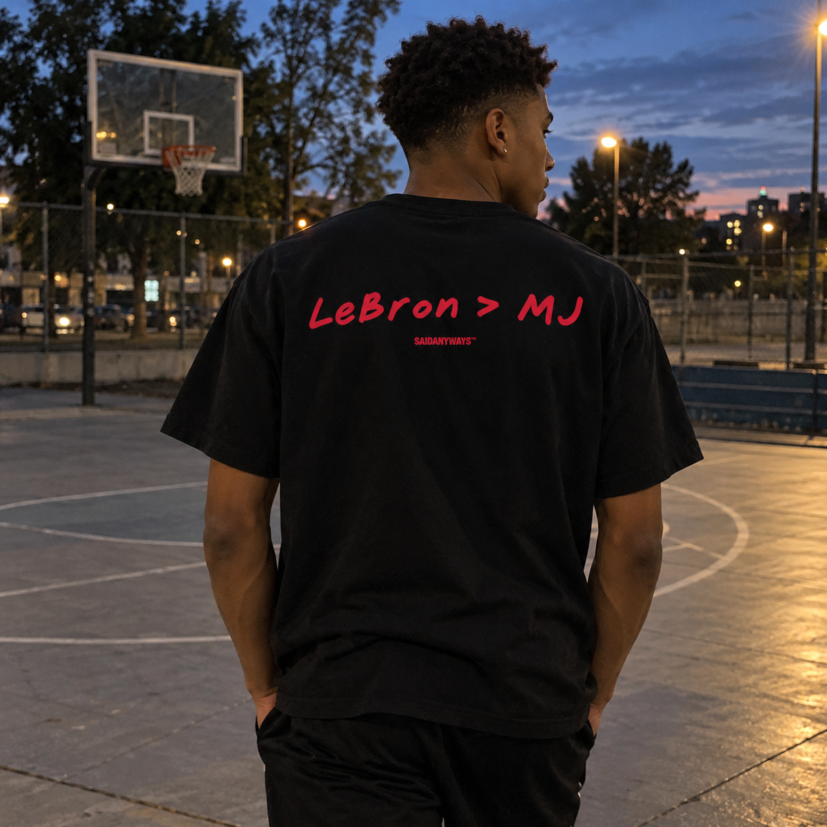 LeBron > MJ Basketball Debate black tee, worn on a basketball court