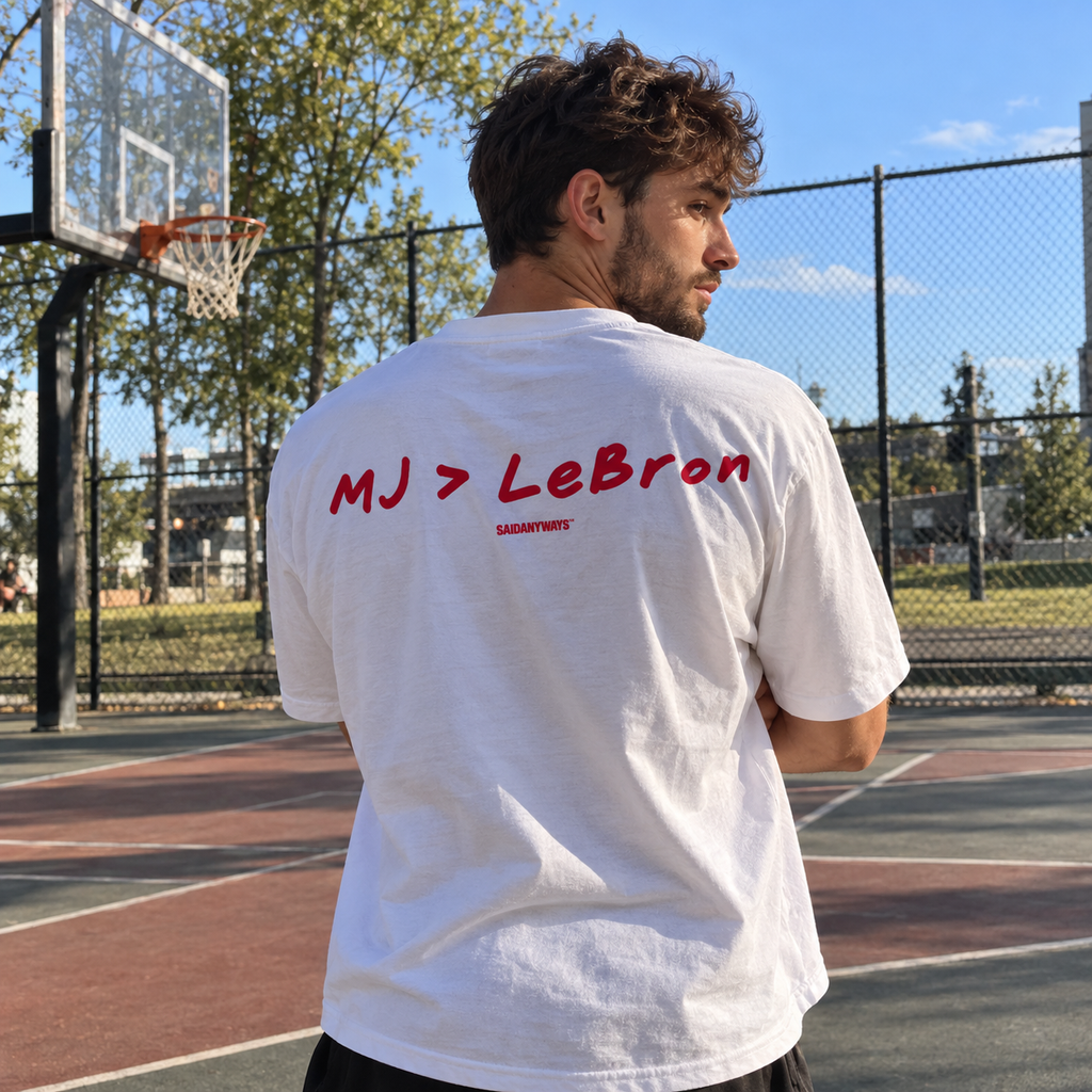 MJ > LeBron Basketball Debate white tee, worn on a basketball court