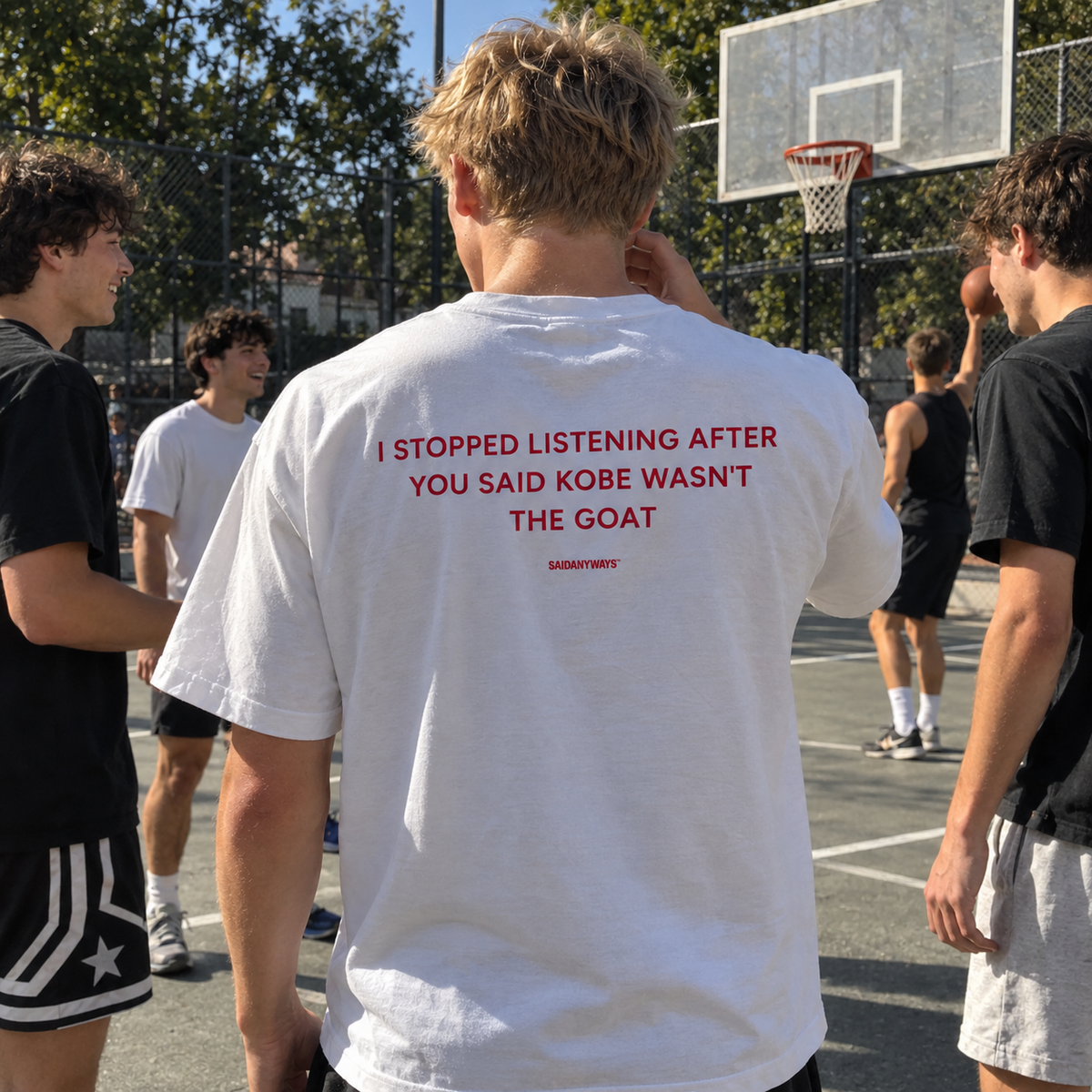 I Stopped Listening After You Said Kobe Wasn't The GOAT white tee, worn among friends on a basketball court
