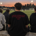 I Stopped Listening After You Said Ronaldo Wasn't The GOAT black tee, worn among friends watching a football match